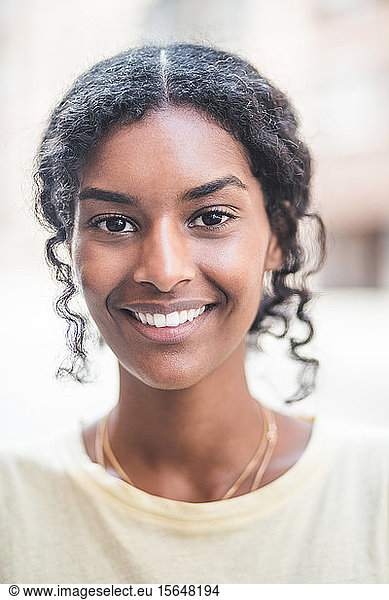 Portrait of smiling woman in city