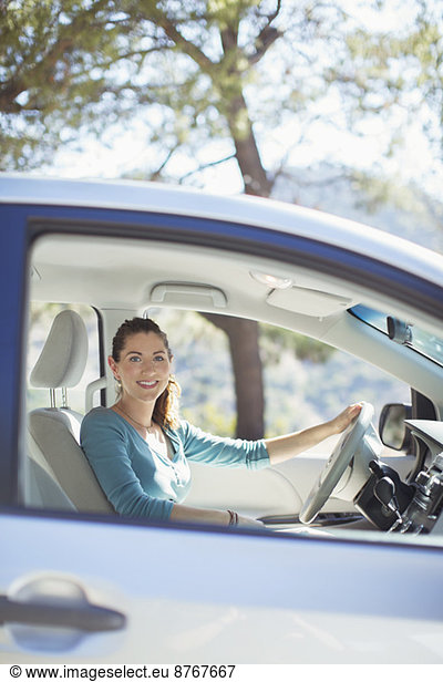 Portrait of smiling woman inside car