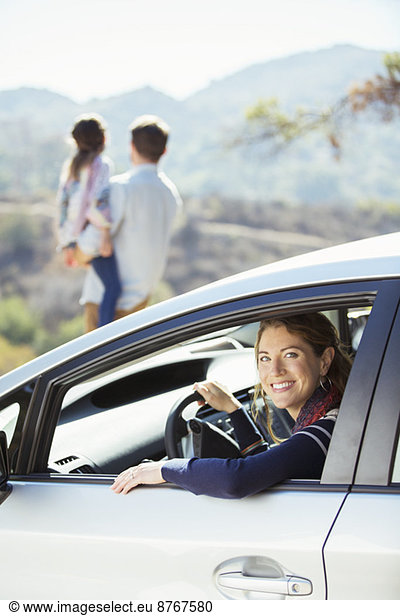 Portrait of smiling woman inside of car