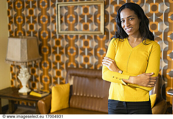 Portrait of smiling woman standing in vintage living room