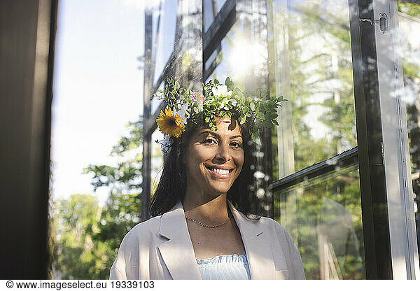 Portrait of smiling woman wearing flower tiara during Swedish midsummer celebration