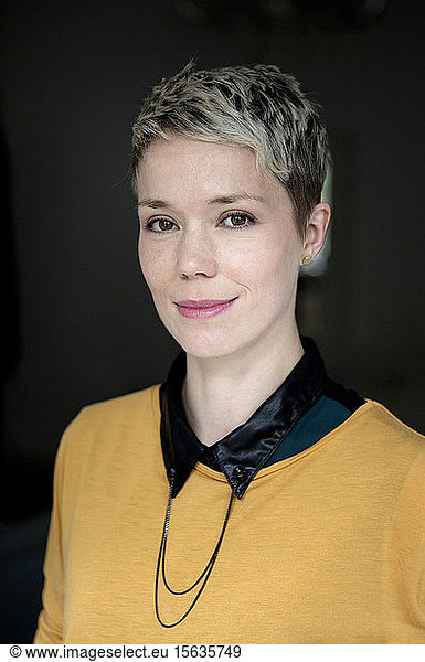 Portrait of smiling woman with dyed short hair