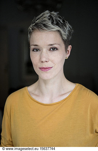 Portrait of smiling woman with dyed short hair