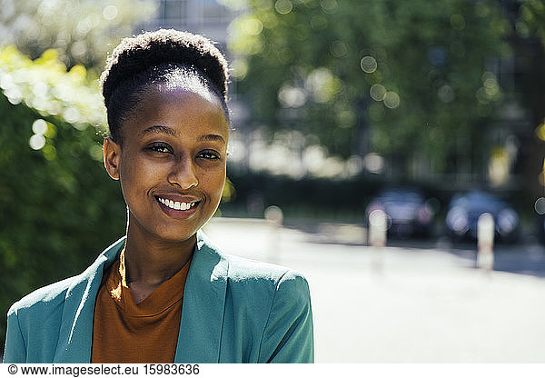 Portrait of smiling young businesswoman outdoors