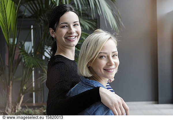 Portrait of smiling young businesswomen in office