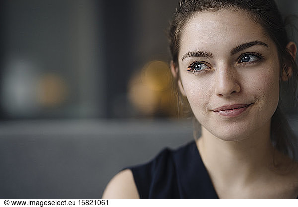 Portrait of smiling young woman looking at distance