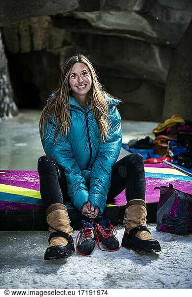 Portrait of smiling young woman sitting in ice caves at Independence Pass