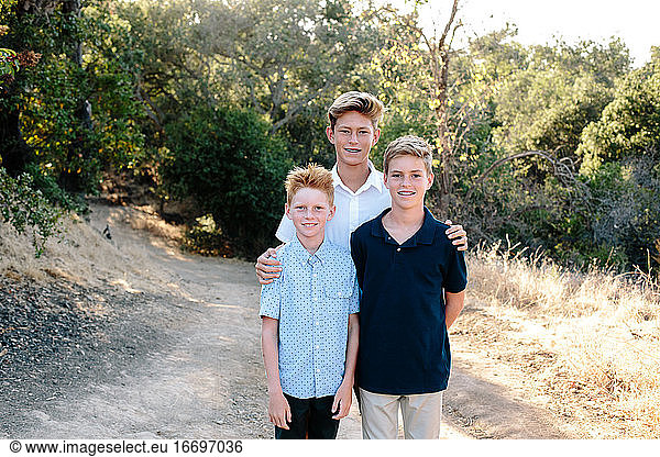 Portrait Of Three Handsome Boys On A Hiking Trail