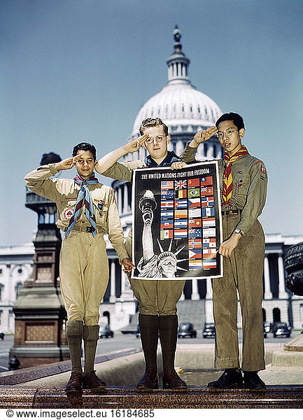 Portrait of Three Saluting Boy Scouts helping to Distribute The United Nations Fight for Freedom Posters to help War Effort  U.S. Capitol in Background  Washington  D.C.  USA  John Rous  U.S. Office of War Information  1943