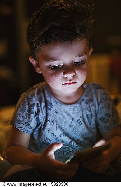 Portrait of toddler looking at smartphone