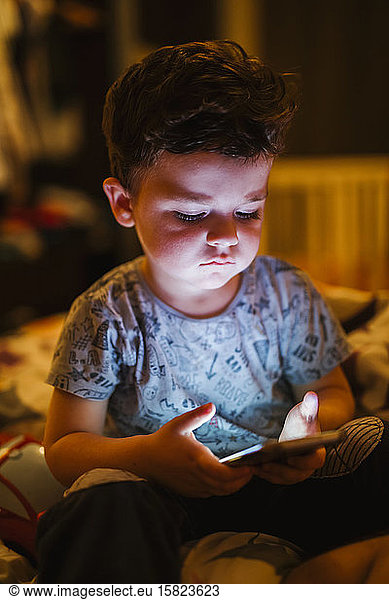Portrait of toddler looking at smartphone