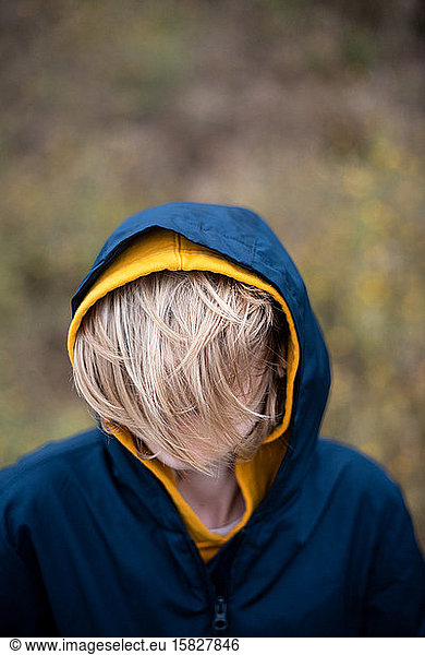 Portrait of tween with hair covering face