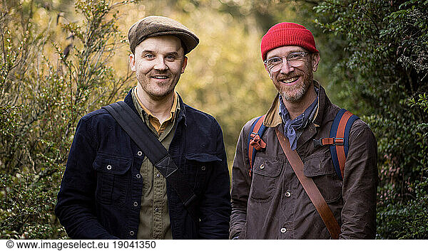 Portrait of two men smiling in nature