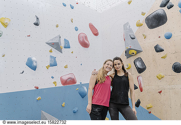Portrait of two smiling women in climbing gym