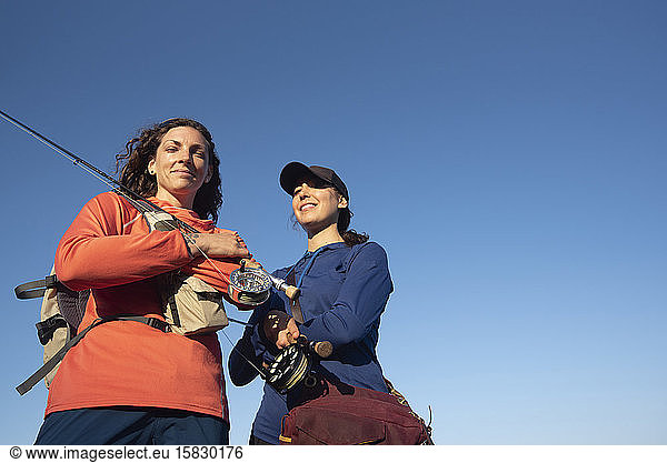 Portrait of two women fly fishing