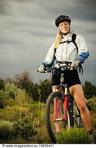 Portrait of woman mountain biking.