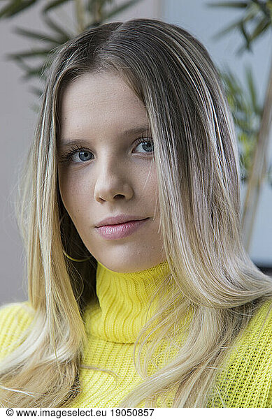 portrait of woman sitting with yellow sweater