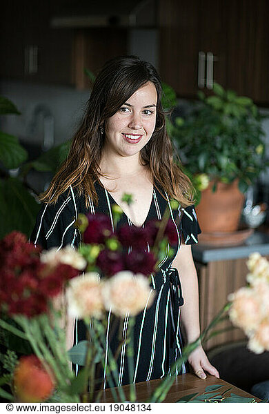 Portrait of woman surrounded by houseplants
