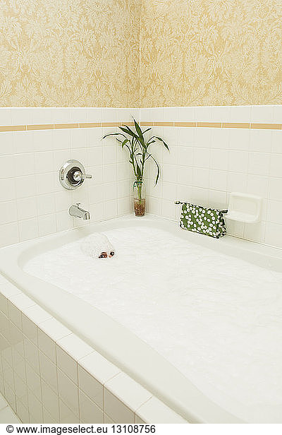 Portrait of woman taking bath in bathtub at home