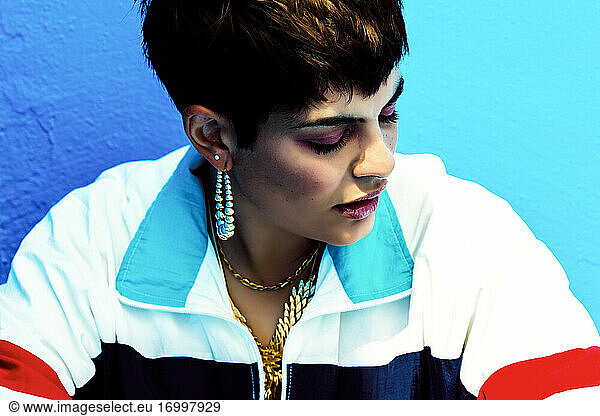 Portrait of woman wearing swag style, closed eyes