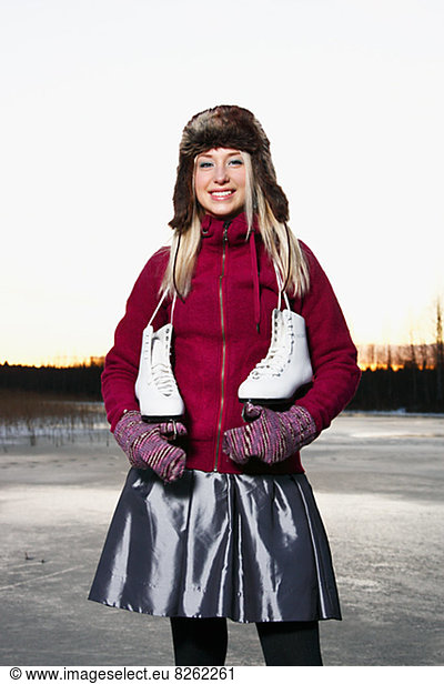 Portrait of woman with ice skates