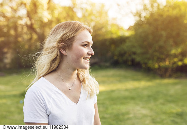 Portrait of young blonde woman looking away