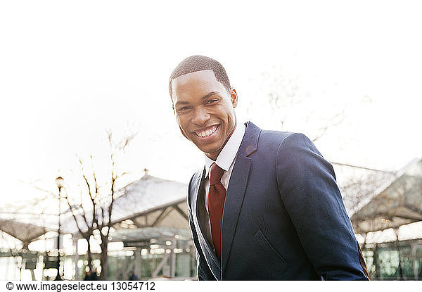 Portrait of young businessman against clear sky