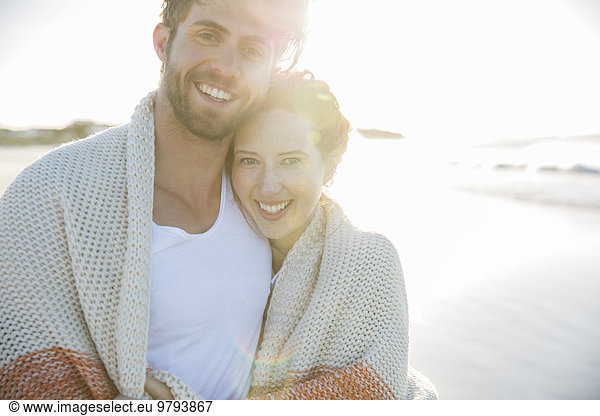 Portrait of young couple standing on beach