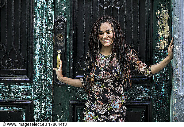 Portrait of Young Cuban Woman laughing standing in doorway