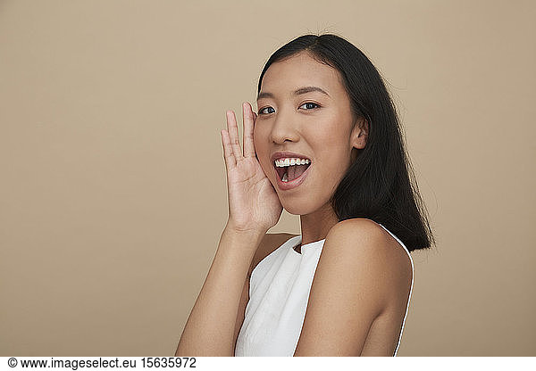 Portrait of young female Chinese woman  open mouth