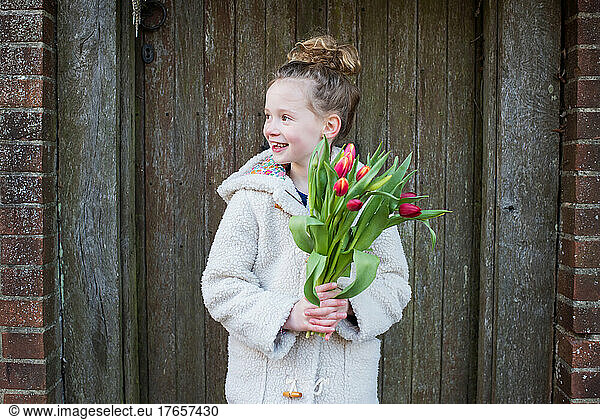 portrait of young girl holding flowers in England