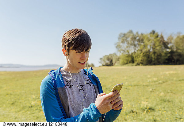 Portrait of young man hiking  listening to music