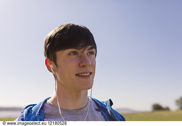 Portrait of young man hiking  listening to music