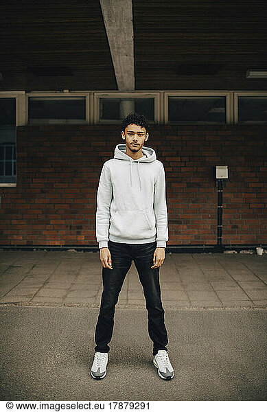Portrait of young man standing on street