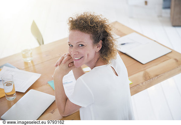 Portrait of young smiling office worker at desk