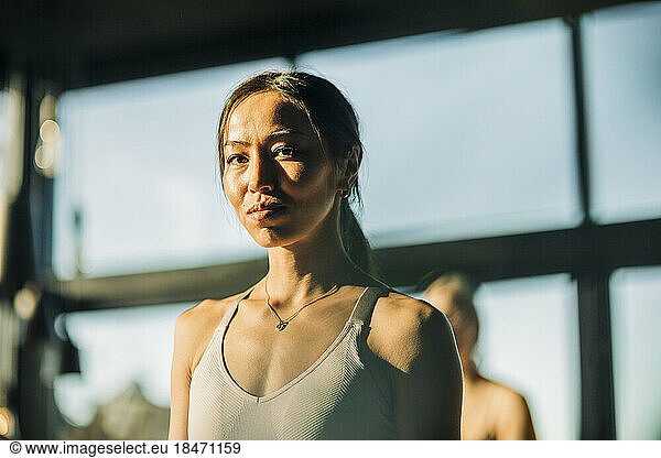 Portrait of young woman at yoga class in retreat center