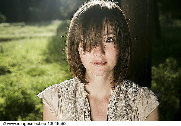 Portrait of young woman with bangs in forest