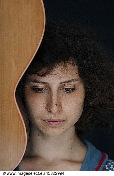 Portrait of young woman with guitar