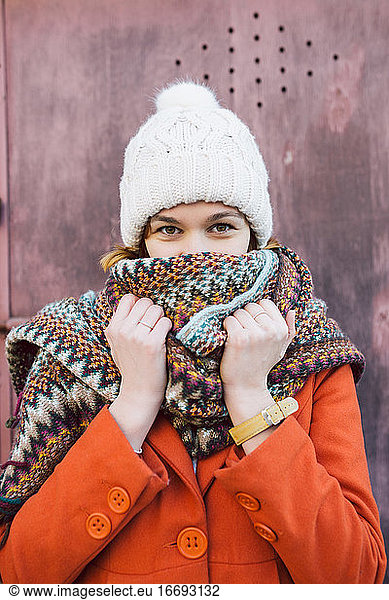 Portrait of young woman with winter hat and scarf