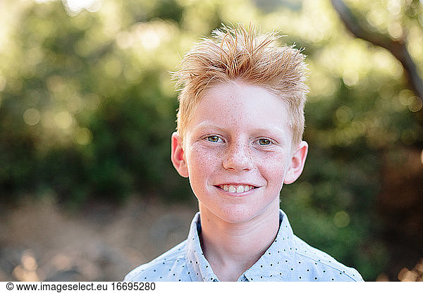 Portrait Outside Of A Red Haired Boy With Freckles