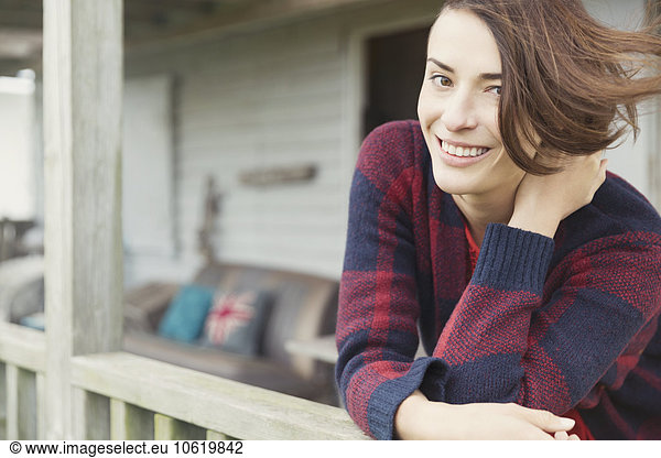 Portrait smiling brunette woman on porch