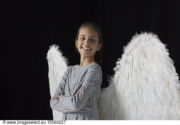 Portrait smiling  confident girl wearing angel wings