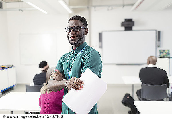 Portrait smiling  confident male community college instructor in classroom