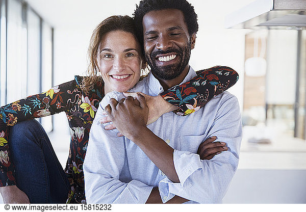 Portrait smiling  confident multi-ethnic couple hugging