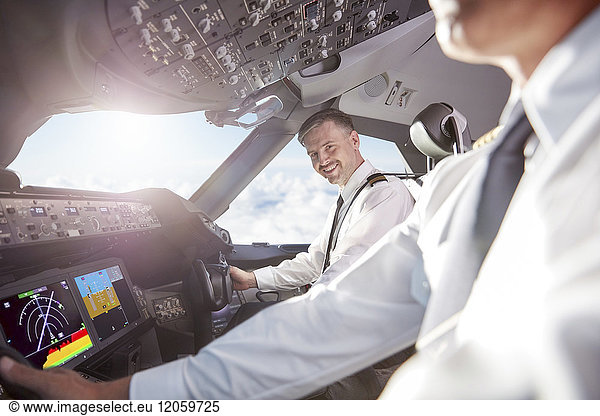 Portrait smiling  confident pilot in airplane cockpit