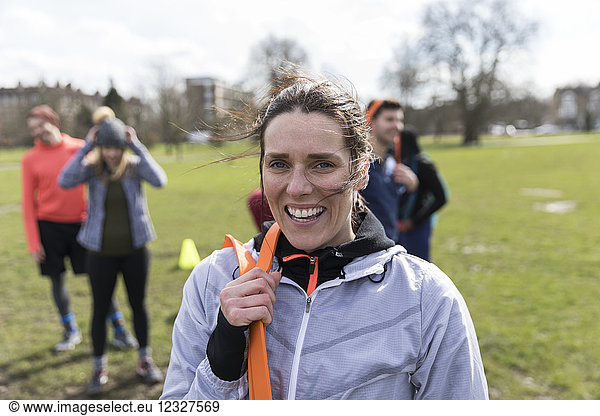 Portrait smiling  confident woman exercising in park