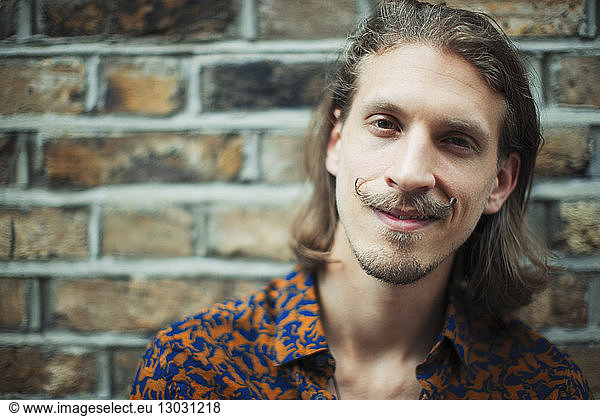 Portrait smiling  confident young male hipster with mustache