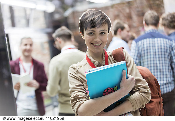 Portrait smiling female college student with backpack and laptop