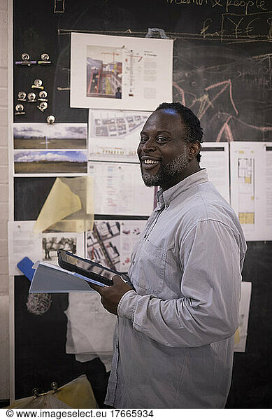 Portrait smiling male architect working in office
