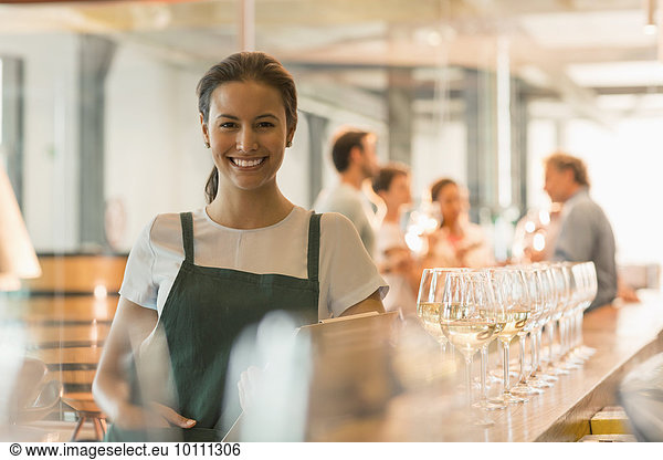 Portrait smiling winery tasting room worker